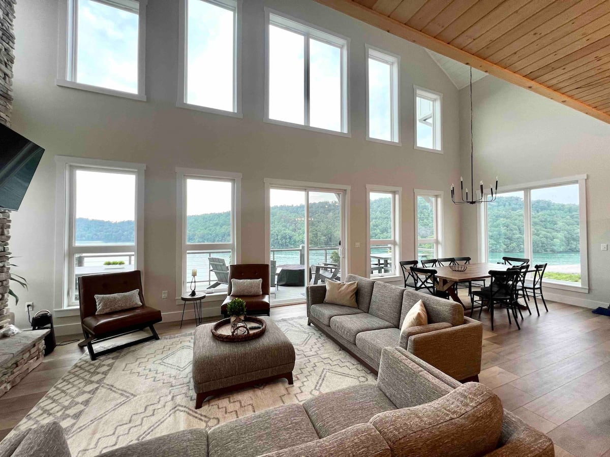 Open living and dining space with wall of windows overlooking Norris Lake