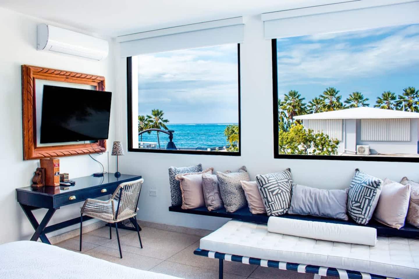 Beachfront suite with a window seat framing the Atlantic in San Juan