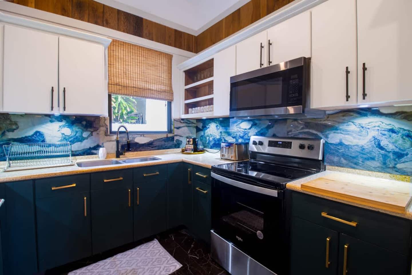 Fully equipped chef kitchen with ocean-blue tile backsplash
